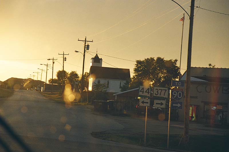 highway signs at sunset